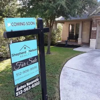 House with realty sale sign